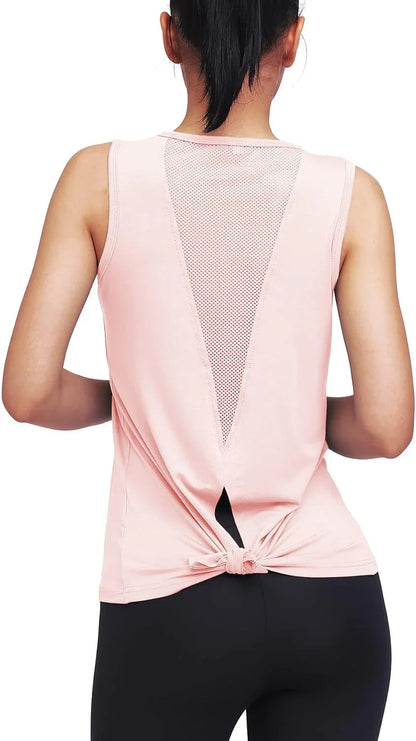 Woman in pink mesh-back workout tank top and black leggings, seen from behind