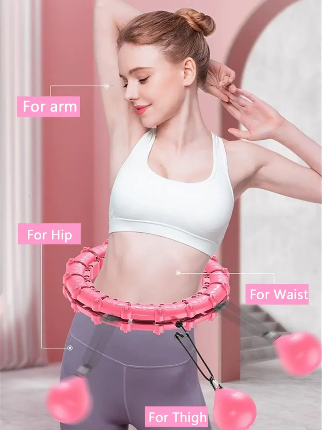 Woman using pink fitness hoop for waist, thigh, arm, and hip workout at home gym