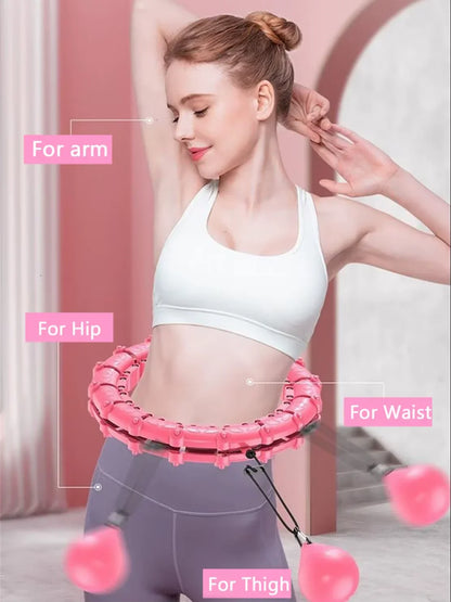 Woman using pink fitness hoop for waist, thigh, arm, and hip workout at home gym